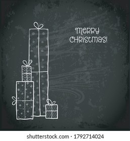Greeting christmas card with pile of gift boxes on blackboard background