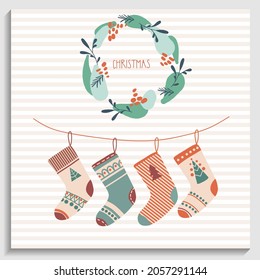 Greeting New Year card, invitation. Christmas wreath with text Christmas and Christmas socks or stockings on the striped background