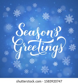 Season’s Greetings calligraphy hand lettering on blue background with bokeh and snowflakes. Merry Christmas and Happy New Year celebration poster. Vector template for greeting card, banner, flyer, etc