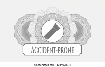 Grey abstract rosette with flashlight icon and Accident-prone text inside