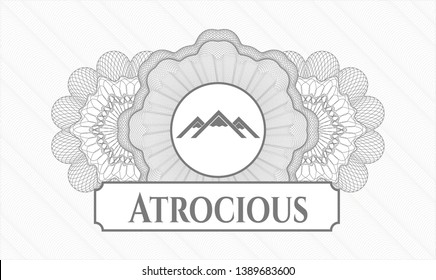 Grey abstract rosette with mountain icon and Atrocious text inside