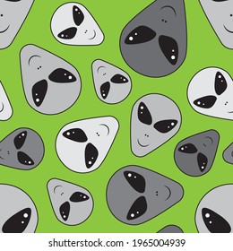 Grey aliens on green background seamless pattern for wrapping, wallpaper, textile, paper, fashion and more. Vector illustration.