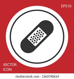 Grey Bandage plaster icon isolated on red background. Medical plaster, adhesive bandage, flexible fabric bandage. White circle button. Vector Illustration