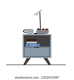 Grey bedside table with books, mug, bowl of cookies, and table lamp.