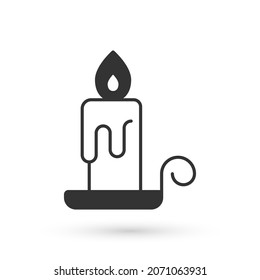 Grey Burning candle in candlestick icon isolated on white background. Cylindrical candle stick with burning flame.  Vector