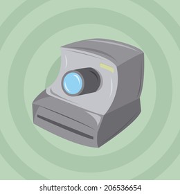 a grey camera in a green background