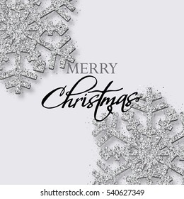 Grey Christmas background with shining silver snowflakes. 