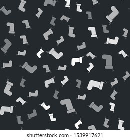 Grey Christmas sock icon isolated seamless pattern on black background.  Vector Illustration