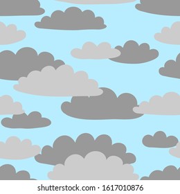 Grey clouds on the background of light-blue sky. Seamless pattern. Vector graphics.