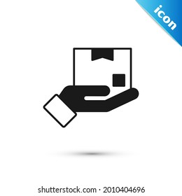 Grey Delivery hand with cardboard boxes icon isolated on white background. Door to door delivery by courier.  Vector