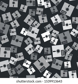Grey Floppy disk in the 5.25-inch icon isolated seamless pattern on black background. Floppy disk for computer data storage. Diskette sign.  Vector Illustration