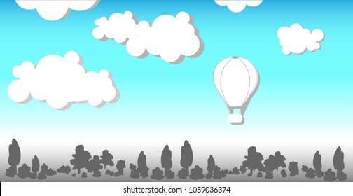 Grey forest against the blue sky and the balloon