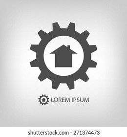 Grey gearwheel with house as construction company logo