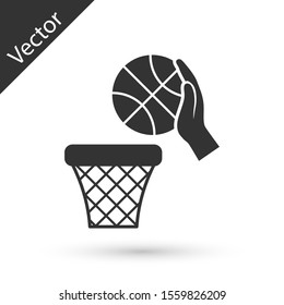 Grey Hand with basketball ball and basket icon isolated on white background. Ball in basketball hoop.  Vector Illustration
