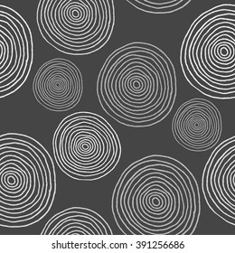 Grey hand drawn circles and rounds on a dark background. Seamless pattern
