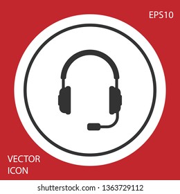 Grey Headphones with microphone icon on red background. Earphones sign. Concept object for listening to music, service, communication and operator. Circle button. Vector Illustration