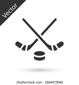 Grey Ice hockey sticks and puck icon isolated on white background. Game start. Vector.
