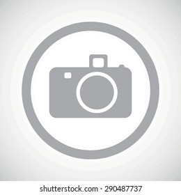 Grey image of camera in circle, on white gradient background