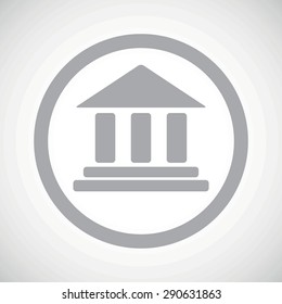 Grey image of classical building with pillars in circle, on white gradient background