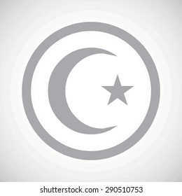 Grey image of crescent moon and one star in circle, on white gradient background