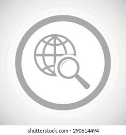 Grey image of globe under loupe in circle, on white gradient background