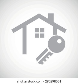 Grey image of house contour and key, on white gradient background