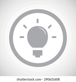 Grey image of light bulb in circle, on white gradient background