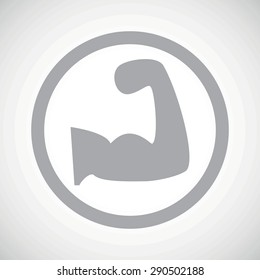 Grey image of muscular arm in circle, on white gradient background