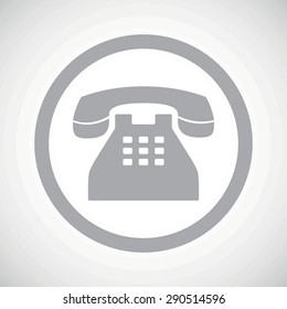 Grey image of old phone in circle, on white gradient background