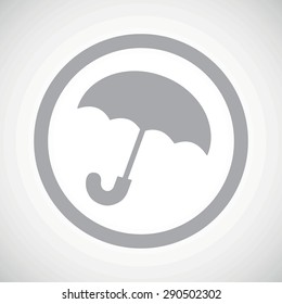 Grey image of open umbrella in circle, on white gradient background