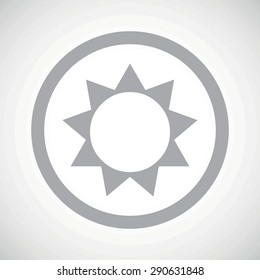 Grey image of sun in circle, on white gradient background
