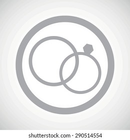 Grey image of wedding rings in circle, on white gradient background