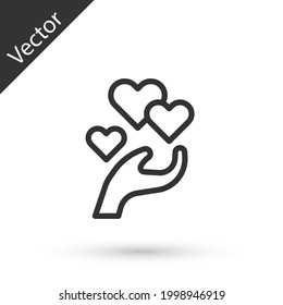 Grey line Heart in hand icon isolated on white background. Hand giving love symbol. Valentines day symbol.  Vector