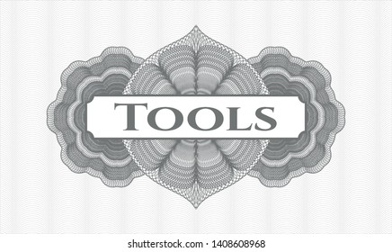 Grey money style emblem or rosette with text Tools inside