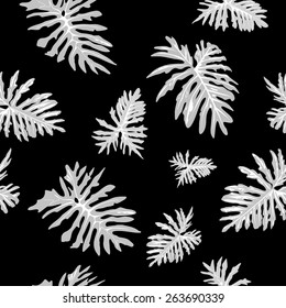 Grey palm leaves on a black background. Seamless pattern.