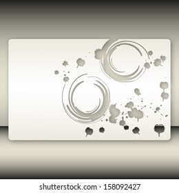 Grey paper background with holes in the form of spots of ink and abstract circles