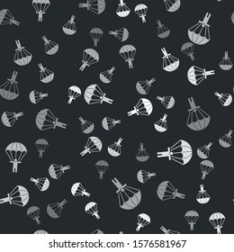 Grey Parachute and silhouette person icon isolated seamless pattern on black background.  Vector Illustration