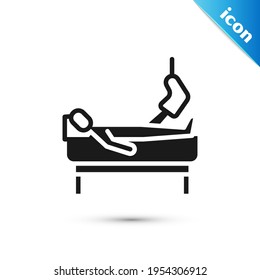 Grey Patient with broken leg is in the hospital icon isolated on white background. Hospitalization of the patient. Sick man in bed.  Vector
