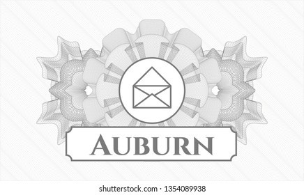 Grey rosette or money style emblem with envelope icon and Auburn text inside