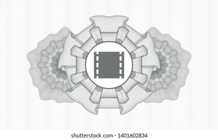 Grey rosette (money style emblem) with film icon inside