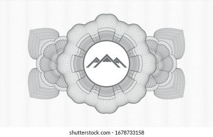 Grey rosette or money style emblem with mountain icon inside