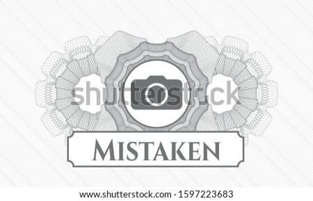 Grey rosette (money style emblem) with photo camera icon and Mistaken text inside