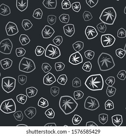 Grey Shield and marijuana or cannabis leaf icon isolated seamless pattern on black background. Marijuana legalization. Hemp symbol.  Vector Illustration