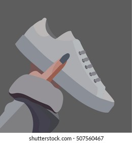grey shoes in hand