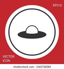 Grey UFO flying spaceship icon isolated on red background. Flying saucer. Alien space ship. Futuristic unknown flying object. Circle button. Vector Illustration