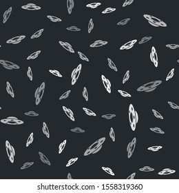 Grey UFO flying spaceship icon isolated seamless pattern on black background. Flying saucer. Alien space ship. Futuristic unknown flying object.  Vector Illustration