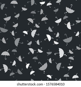 Grey Umbrella and rain drops icon isolated seamless pattern on black background. Waterproof icon. Protection, safety, security concept. Water resistant symbol.  Vector Illustration