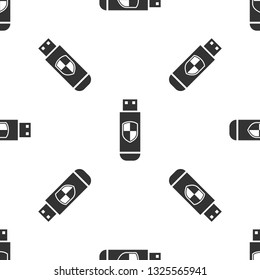 Grey USB flash drive and protection shield icon isolated seamless pattern on white background. Vector Illustration