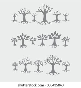 Grey vector tree silhouettes with roots on grey background