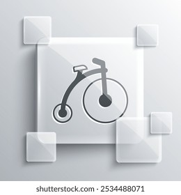 Grey Vintage bicycle with one big wheel and one small icon isolated on grey background. Bike public transportation sign. Square glass panels. Vector